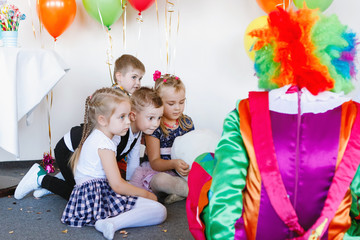 Children play with a clown