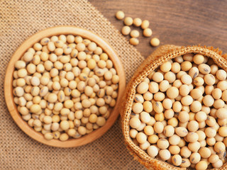 Top view soybeans in sackcloth bag on wooden background, Protein plant health food..