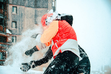 Fototapeta na wymiar Snowball fight in the winter in the snow
