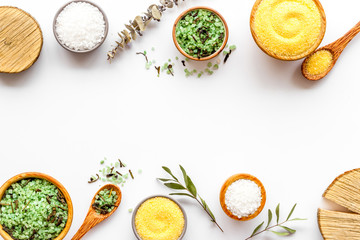 Spa cosmetics. Set of salt in bowls on white wooden background top-down frame copy space