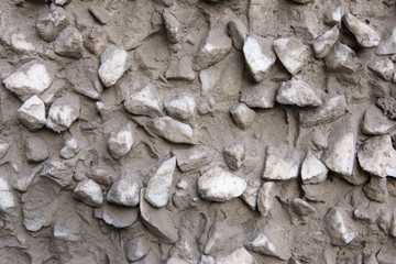 White stones in solidified gray concrete for background.