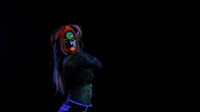 Mystic Female Avatar, Alien or Modern Millennial person. Unique Makeup Technique with UV Colour Pigment. Fluorescent Make-up on Girl Body, Sparkle in Neon Light. Cyan Eyes with UV Lenses.