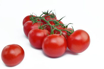 Branch of delicious fresh tomatoes, isolated on white background. Close up