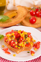 Friselle with tomatoes and mais.