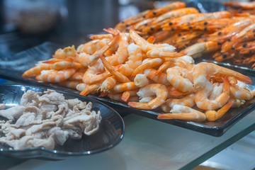 Closeup photo of boiled pork fillet and peeled prawns 