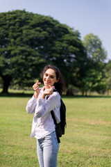 Beautiful young woman hands showing mini heart at public park in the morning,Happy and smiling,Relax time