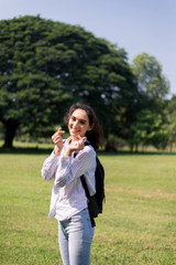 Beautiful young woman hands showing mini heart at public park in the morning,Happy and...