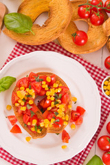 Friselle with tomatoes and mais.