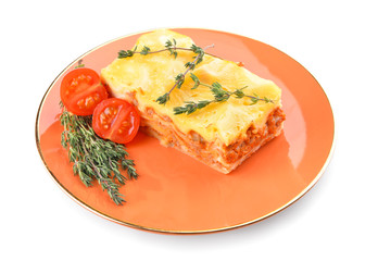 Plate with piece of tasty homemade lasagna on white background