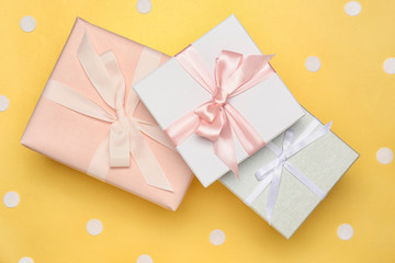 Beautiful gift boxes on color background