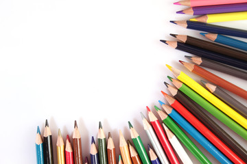 Colored pencils lie in a row