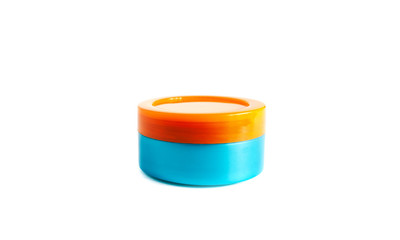 Cosmetics jar for cream colored in orange and blue, isolated on white