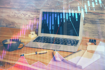 Double exposure of chart and financial info and work space with computer background. Concept of...