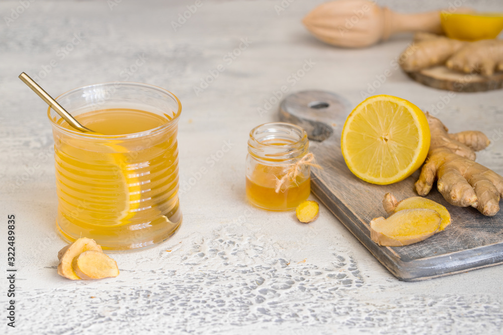 Wall mural ginger tea with honey and lemon. warm revitalizing beverage used to help relieve cold and flu sympto