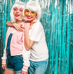 Two young sexy smiling hipster girls in white wigs and red lips.Beautiful trendy women in summer...