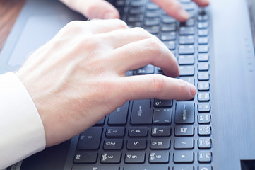 Closeup of businessman typing on laptop computer