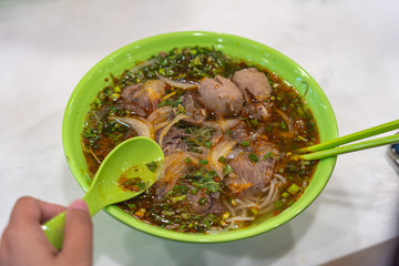 Human eating Vietnamese beef noodles- Bun Bo Hue