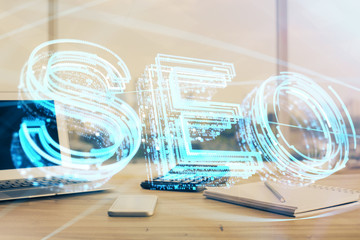 Multi exposure of table with computer and seo drawing hologram. Search optimization concept.