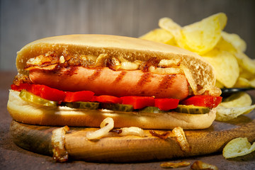 Hot dog with cucumbers, peppers and fried onions.