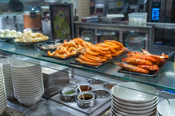 Fresh boiled tiger shrimps and ingredients in restaurant's kitchen 