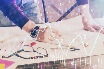 Multi exposure of man standing and planing investment with stock market forex chart.