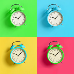 Multicolored alarm clocks collage on bright colorful backgrounds. Top view. Flat lay