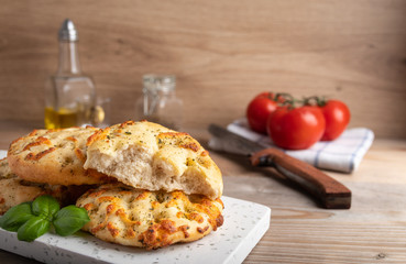 Freshly baked Italian bread Focaccia on a white stone plate.