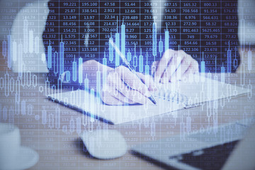 Forex graph on hand taking notes background. Concept of research. Multi exposure