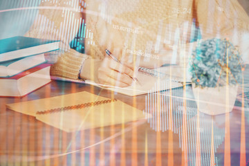 Obraz premium Forex graph on hand taking notes background. Concept of research. Double exposure
