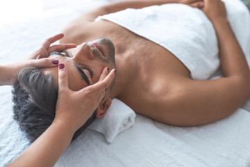 Face Massage. Close-up of a Young Male Getting Spa Treatment.