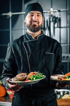 Smiling Chef Serving Organic Vegan Burger with Fresh Salad