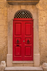 Vintage red door on stone house