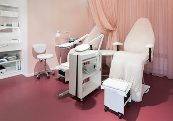White leather pedicure chairs with professional equipment