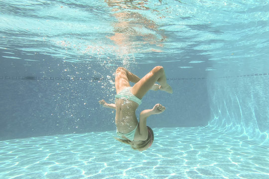 Pretty little girl in swimming pool , summer vacations.