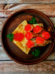 Pancakes with red caviar. Russian traditional dish.