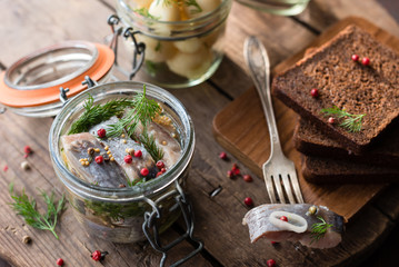 Marinated or Pickled Herring with Pink Peppercorn, Mustard Seeds and Dill in Glass Jar