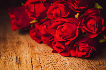Red roses on top of wooden board. Vintage look. Leave some copyspace. Valentine's day. Love occasion.