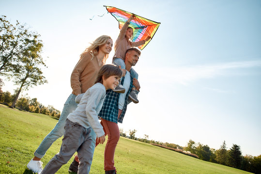 Caring. Honesty. Respect. Responsibility. Happy family playing a kite. Outdoor family weekend
