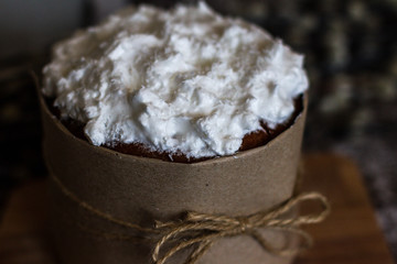Easter. kulich on a dark background. Cake with white icing. Birthday cake. palm Sunday. Pie and willow branches. Bow from a rope. Wonderful decoration. Homemade cake. Delicious and beautiful pastries