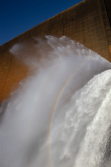 Rainbow in rushing water at Tinaroo Falls Dam on the Atherton Tableland in Queensland, Australia