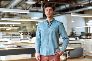 Well organized for well satisfied. Young businessman posing in office