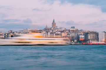 Naklejka premium Istanbul, Turkey - Jan 15, 2020: Galata Tower with Ferry Boat in Golden Horn , Istanbul, Turkey,
