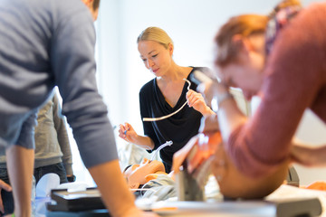 Medical doctor expert instructor displaying method of patient intubation on medical education...