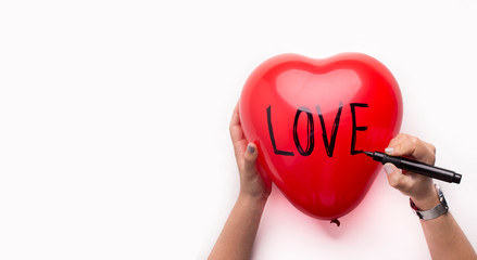 Female writing creative text love on balloon heart, white