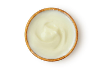 Yogurt in wooden bowl on white background