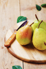 Naklejka na ściany i meble Fresh organic ripe pears on wooden board.