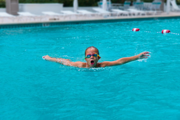 boy swim in butterfly style at pool, kids competition, children sport