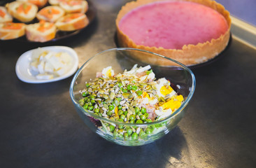 Healthy food in the kitchen. Fresh salad and cheesecake. Vegetarian concept. Hipster lunches.