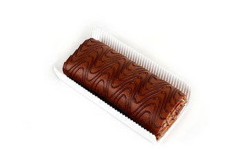 Chocolate biscuit roll cake in package, isolated on white background.