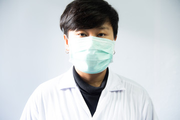 Doctor in white coat on grey background.